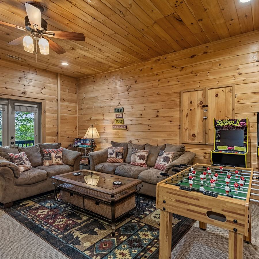 Downstairs game room with the foosball table and arcade cabinet