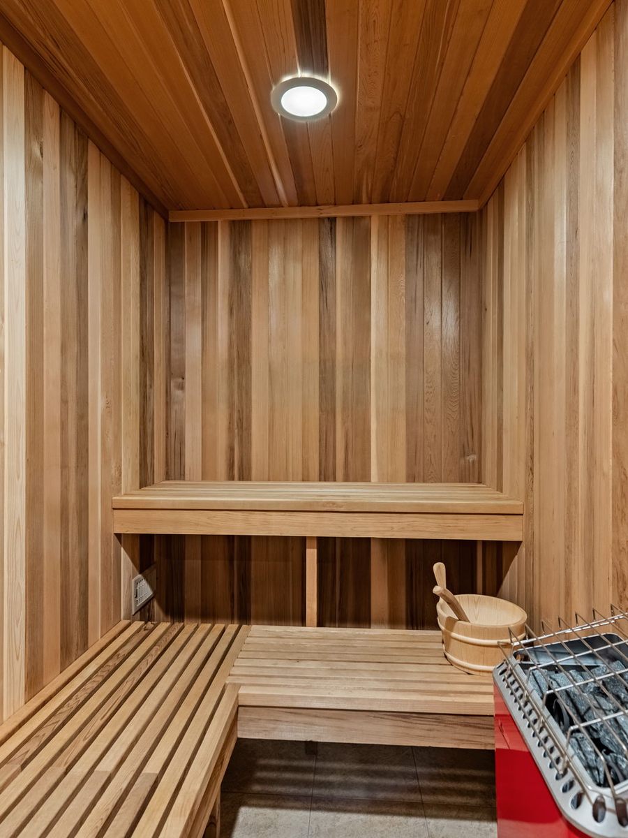 Inside the handmade Finnish sauna, cedar benches and the heater